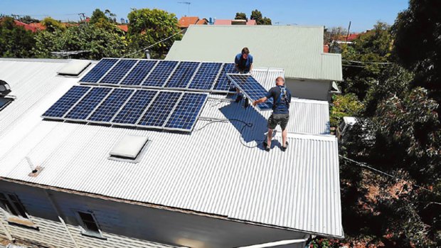 Peter Allan (top) removes solar panels from his Brunswick house in frustration at Government policies.