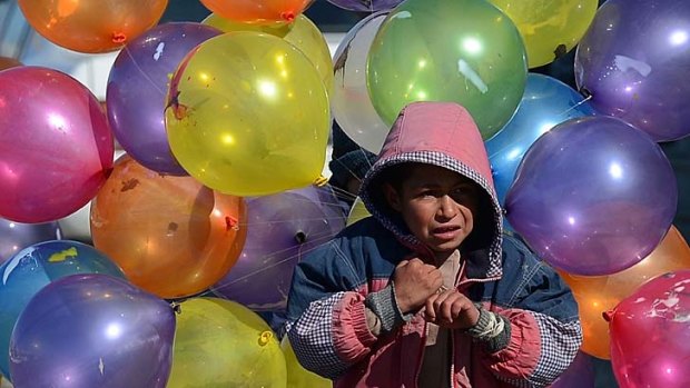 Survival &#8230; a boy sells balloons in the Afghan capital, Kabul, last week. US-led forces in the country are accused of using incautious military tactics that put children in danger.