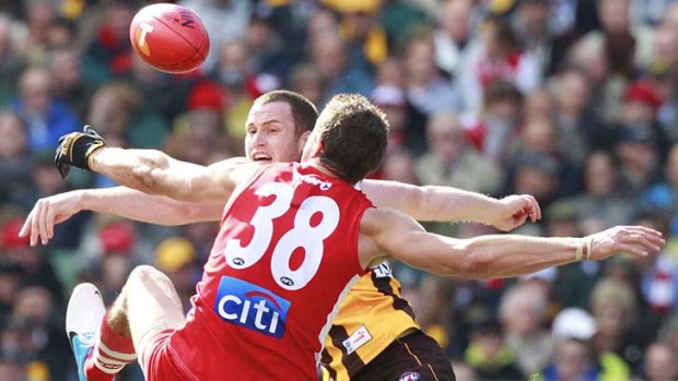 Sydney’s Mike Pyke  and Hawthorn’s Jarryd Roughead in last year’s grand final.