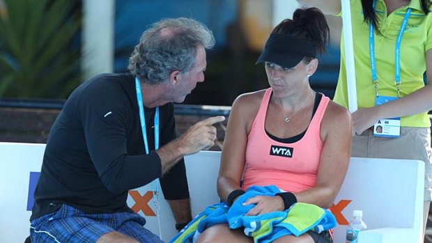 Casey Dellacqua Australia talks with her coach at the Sydney International.