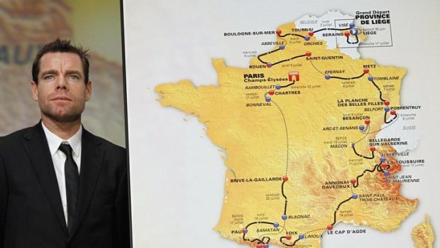 Cadel Evans poses next to the newly-released itinerary of the 2012 Tour de France.