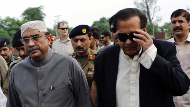 Returned to Pakistan ... President Asif Ali Zardari, left, shown walking with Pakistani Punjab governor Salman Taseer in 2010.