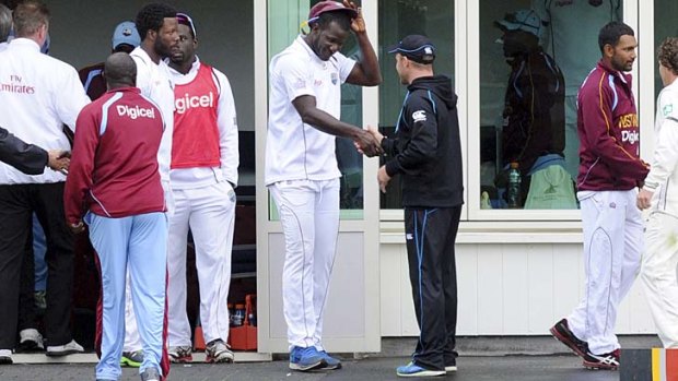 West Indies captain Darren Sammy shakes hands with his New Zealand counterpart Brendon McCullum after the first Test ended in a draw on Saturday.
