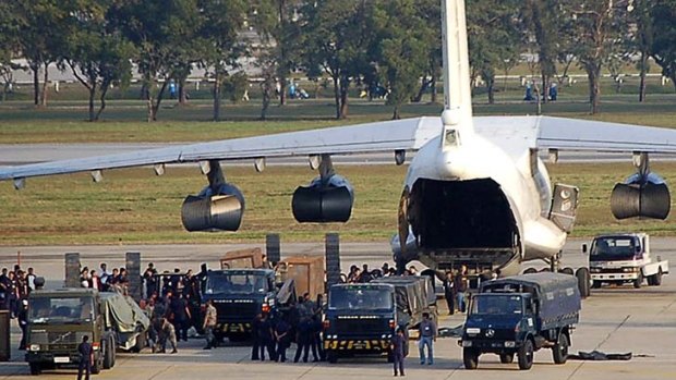 Thai security personnel surround the cargo plane loaded with smuggled weapons at Bangkok airport on December 12, 2009.