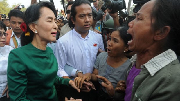 Myanmar democracy leader Aung San Suu Kyi speaks with locals during her visit at a village near the Chinese-backed copper mine project, in Monywa northern Myanmar.