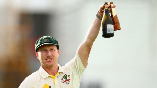 Victory toast: Brad Haddin celebrates with a beer and a bottle of bubbly.