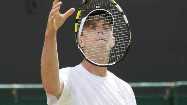 Sam Querrey of the US throws his racquet in the air.