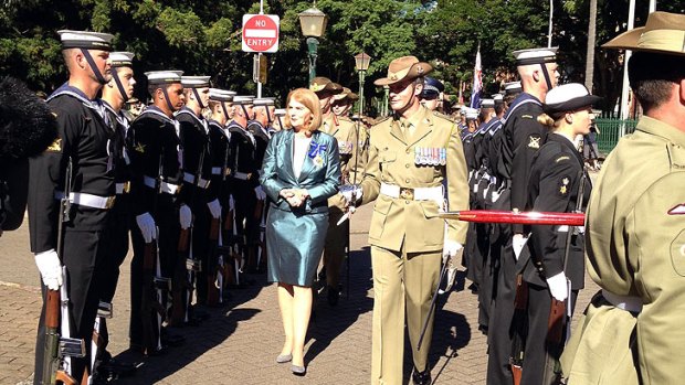 Governor Penelope Wensley inspects the guard outside Parliament.