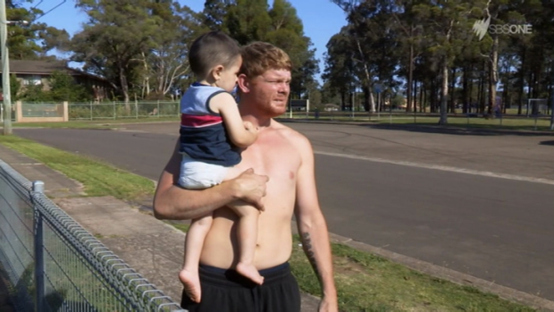 Ice addict Corey holds his son Liam in the final episode of <em>Struggle Street</em>.