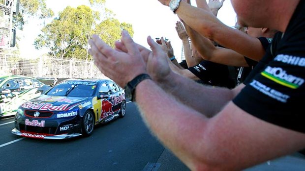 Top gun: Jamie Whincup draws applause from pit lane after winning his fifth V8 Supercars title.