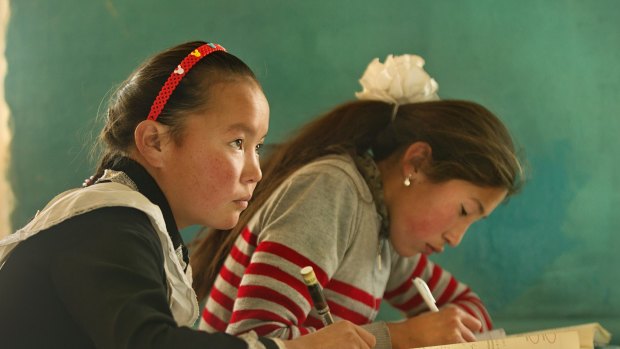 Aisholpan (left) at school, in The Eagle Huntress.