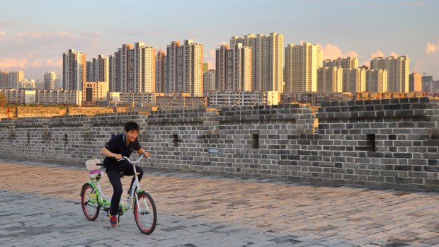 Locals enjoy cycling on Datong's replica ''ancient'' city wall, a legacy of mayor Geng Yanbo.