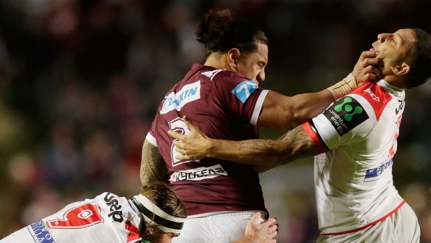Don't argue: Jorge Taufua fends off the Dragons defence.