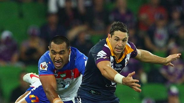 Billy Slater is chased by Zane Tetevano during the match between Melbourne and Newcastle.