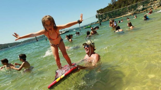 Up and away ... Craig Gill and his daughter Petal, 5, take to the water at Nielson Park yesterday as the temperature rose.