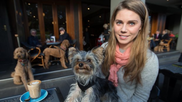 Kat Gaylard and her dog, Harvey Howard, enjoy a visit to a cafe in South Yarra. 