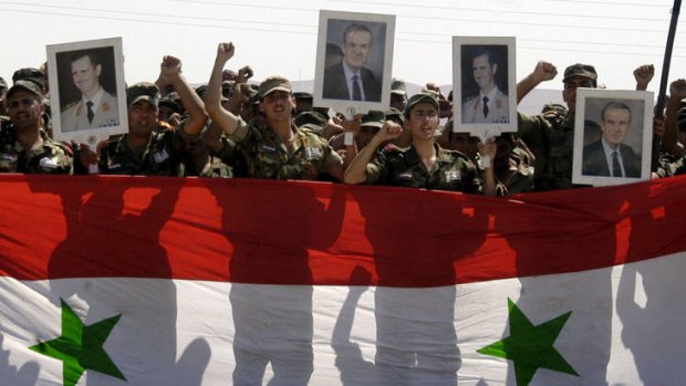 Syrian government forces demonstrate  at the monument of the Unknown Soldier in Damascus.