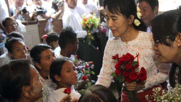 Aung San Suu Kyi comforts HIV patients in Rangoon.
