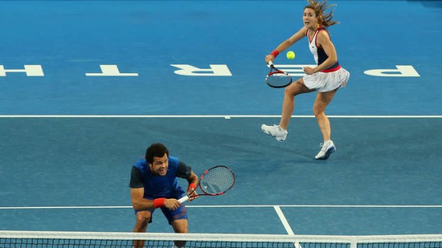 Alize Cornet and Jo-Wilfried Tsonga of France play in  in the mixed doubles match against Petra Kvitova and Radek Stepanek of the Czech Republic.