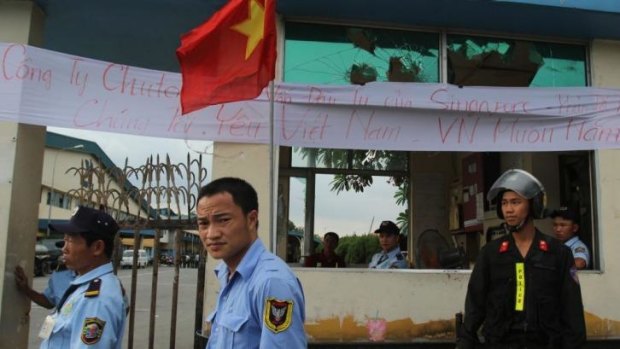 Security staff guard the entrance to a Singaporean factory in an industrial park in Binh Duong province, Vietnam.