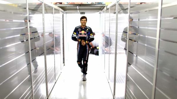 Still confident ... Mark Webber enters the garage in Brazil during the week. He is trailing championship leader Fernando Alonso by just 11 points with two races to go.