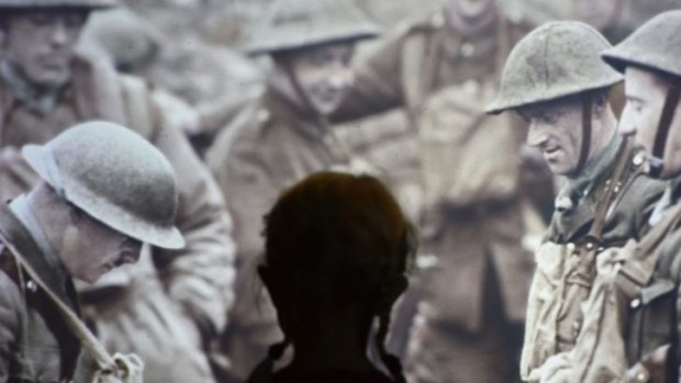 A child looks at a projected stills image of WWI soldiers. The First World War Galleries tell the story of the war and feature over 1,300 objects from diaries and personal mementos through to weapons, posters and film. 