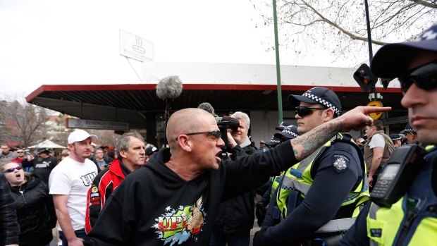 An anti-mosque protester yells over police lines at the rally. 