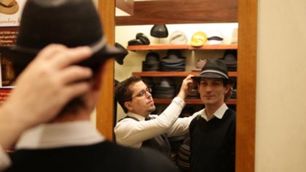 Suits you, sir ... milliner Robert Carroll from Strand Hatters with some of the hats men are buying.