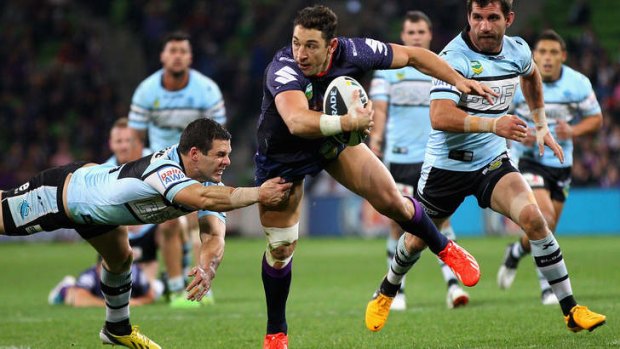 Coming through: Billy Slater avoids a school of Sharks in Storm's big win over Cronulla.