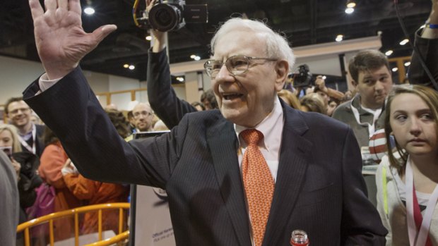 Warren Buffett greets shareholders while touring the exhibit floor prior to holding the Berkshire Hathaway shareholders meeting in 2013.