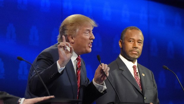 Ben Carson, right, watches as Donald Trump speaks during the debate in Colorado. 