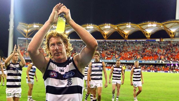 Cameron Ling of the Cats applauds Geelong fans in the crowd of the Sun's new Metricon Stadium in the Gold Coast.