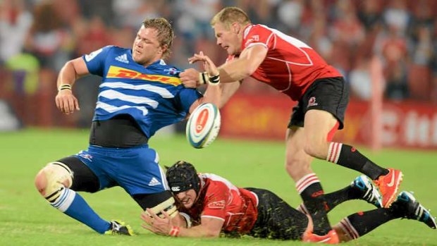 Upset: Jaco Kriel and Deon van Rensburg of the Lions tackle Duane Vermeulen of the Stormers during the Super Rugby match against the Stormers at Ellis Park.