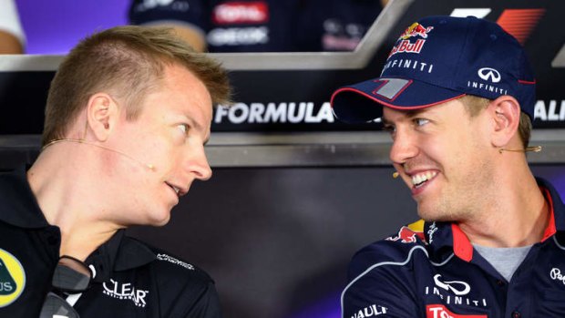 Own man: Kimi Raikkonen chats with Red Bull's Sebastian Vettel.
