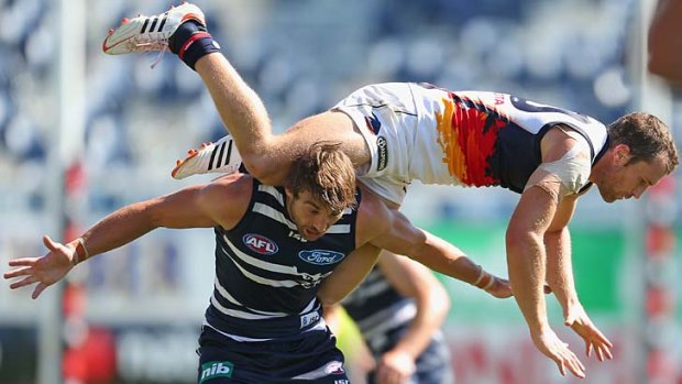 Over the top: Adelaide's Jason Porplyzia tries to take a mark on the shoulders of Geelong's Corey Enright.