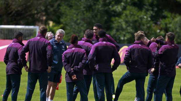 Sweating it up: Roy Hodgson and his England squad trained in three layers of clothing at their base in the Algarve, Portugal on Wednesday.