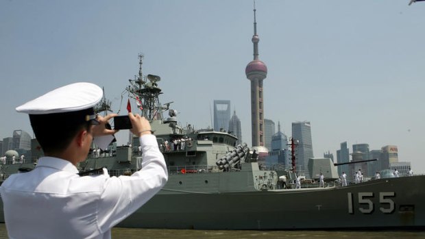 The HMAS Ballarat arriving in Shanghai's historic Bund.