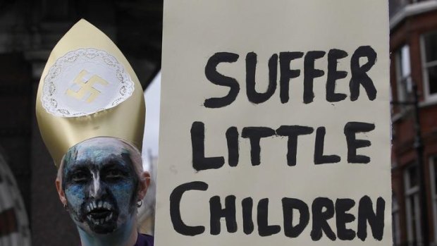 A protester holds a banner during the visit of Pope Benedict XVI in London in 2010.