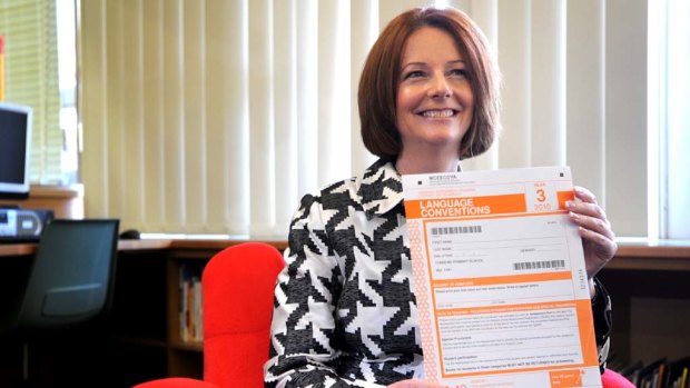 Prime Minister Julia Gillard holding a NAPLAN test.