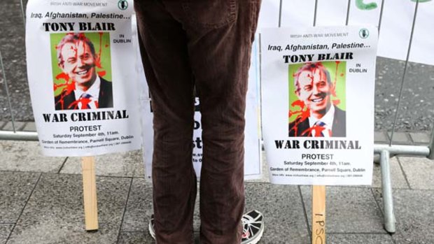 Demonstraters protest outside a bookshop in Dublin, as former British Prime Minister, Tony Blair, signs copies of his book inside.