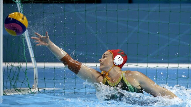 Australian goalkeeper Alicia McCormack denies Great Britain with a diving save.