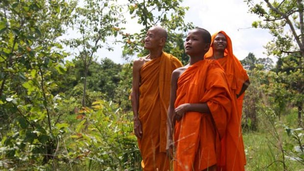 Reclaiming the land ... monks in their forest. They want to earn money from rich countries by conserving the forest to sequester carbon.