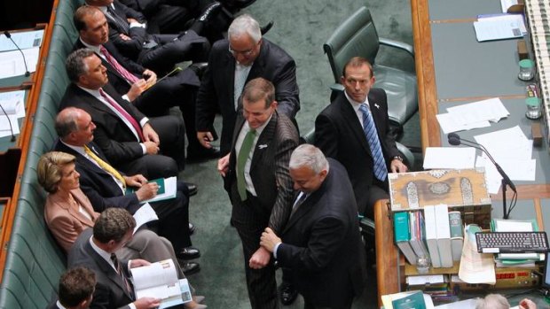 The now ex-Liberal Peter Slipper is dragged to the Speaker's chair, as dictated by parliamentary tradition.