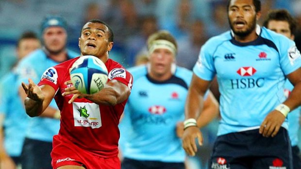 Where there's a Will . . .  Queensland halfback Will Genia spreads the ball during the Reds' heavy second-round loss to the Tahs. Saturday's rematch will be crucial in deciding which side tops the Australian conference.