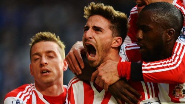 Jubliant: Fabio Borini, centre, celebrates after scoring a penalty to secure Sunderland an upset win over Chelsea and, possibly, Premier League survival.