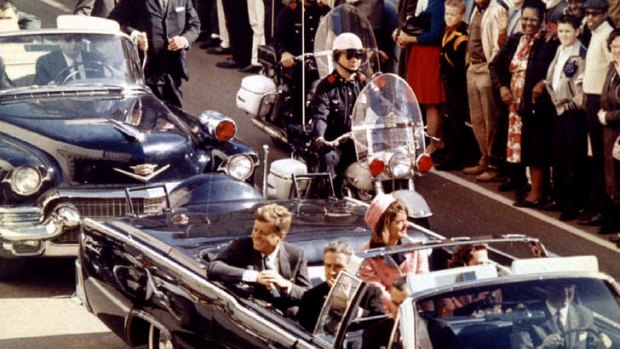 John F. Kennedy and Texas govenor John Connally ride through Dallas just moments before Kennedy was assassinated.