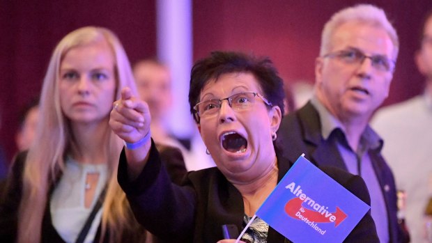 Guests at an Alternative for Germany party, AfD, election party react to the first projections for the German election in Erfurt.