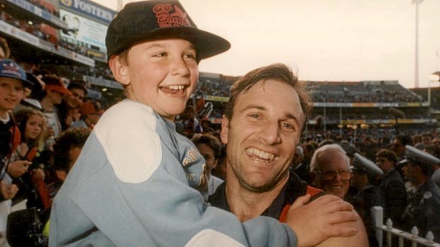Tim Watson celebrates with then eight-year-old Jobe after the 1993 grand final.