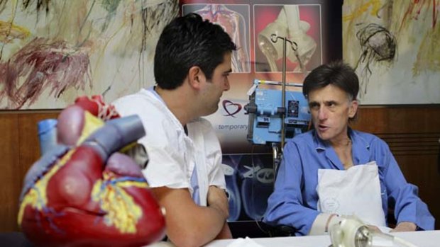 St Vincent s hospital heart surgeon Dr Paul Jansz talks with artifical heart surgery patient Angelo Tigano, 50, the first recipient of the total artificial heart in the Southern Hemisphere.