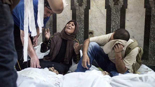 Grief: A family member of a supporter of Mohamed Mursi mourns at the Fateh Mosque.